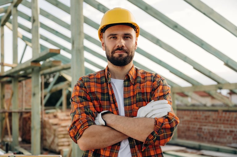 Handsome construction worker on a roof